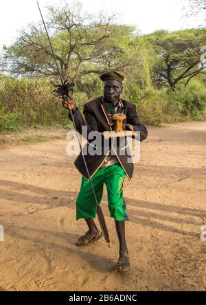 Toposa tribe man dancing with a spear and a wooden seat, Namorunyang State, Kapoeta, South Sudan Stock Photo