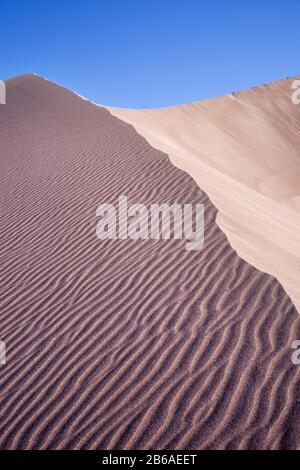 Desert sand with ripples and blue sky Stock Photo - Alamy