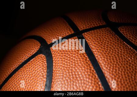 A close-up of a leather basketball on black Stock Photo