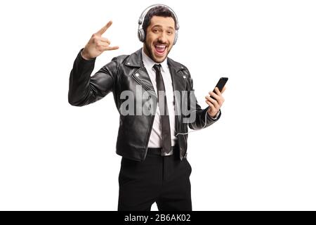Cheerfull guy listening music with headphones and gesturing a rock and roll sign isolated on white background Stock Photo