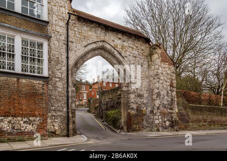 A view up Castle Hill through Castle Arch. The ancient stone archway is a remnant of the town's castle wall. Guildford, Surrey, England. Stock Photo