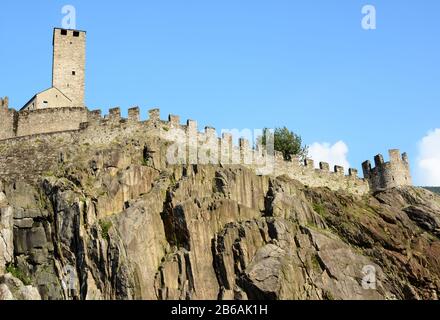 BELLINZONA, SWITZERLAND - July 4, 2014: The Torre Bianca (White tower) and ramparts of the Castelgrande in Bellinzona, Switzerland. A UNESCO World Her Stock Photo