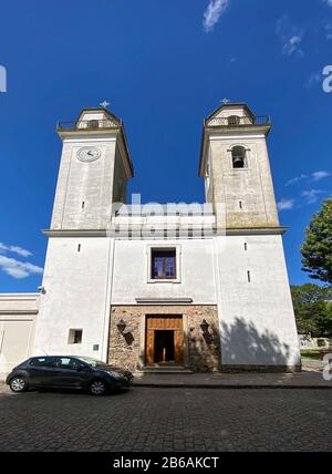 Basilica del Santisimo Saramento; Catholic church, old stone building, religious, exterior, 1808, by Portugese, cobblestone street, car parked, Barrio Stock Photo