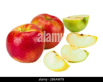 Whole red apples fruit with green, yellow slices isolated on white Stock Photo