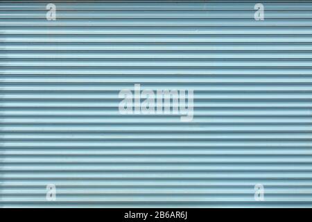 Abstract texture for the backdrop, light blue steel roller shutters. Closed showcase background. Stock Photo
