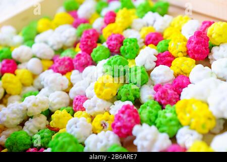 Colorful glazed nuts and candies sweets background lay flat. Stock Photo