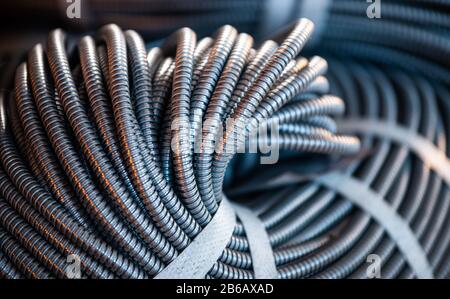 Close-up of a huge bundle of metal flexible tubes interconnected in a factory or industry plant. The concept of modern mining or IT of high-tech indus Stock Photo