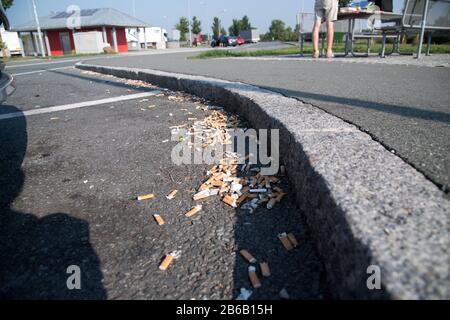 Used smoked cigarette stubs on rest area on Bundesautobahn 9, Germany. August 25th 2019 © Wojciech Strozyk / Alamy Stock Photo Stock Photo