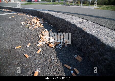 Used smoked cigarette stubs on rest area on Bundesautobahn 9, Germany. August 25th 2019 © Wojciech Strozyk / Alamy Stock Photo Stock Photo