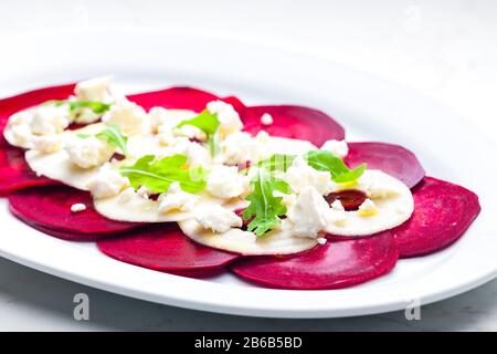 fresh beetroot and apple salad with fresh goat cheese and arugula Stock Photo