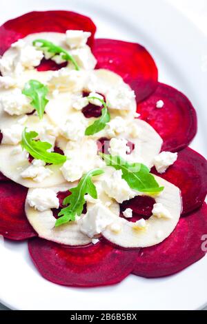 fresh beetroot and apple salad with fresh goat cheese and arugula Stock Photo