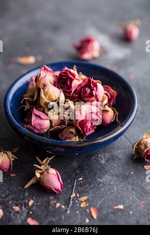 Dried pink rose buds on dark background Stock Photo