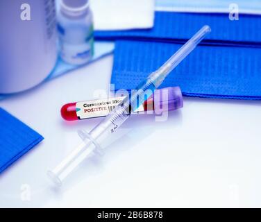 Coronavirus vaccine injection against positive blood test in vacuum tube. Coronavirus vaccine concept. Stock Photo
