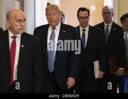 Washington, United States. 10th Mar, 2020. President Donald Trump (2nd-L), joined by Treasury Secretary Steven Mnuchin, leaves a meeting with Senate Republicans on a possible economic package in the wake of market turbulence caused by the Coronavirus, on in Washington, DC on March 10, 2020. Photo by Kevin Dietsch/UPI Credit: UPI/Alamy Live News Stock Photo