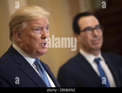 Washington, United States. 10th Mar, 2020. President Donald Trump (C), joined by Treasury Secretary Steven Mnuchin, speaks after meeting with Senate Republicans on a possible economic package in the wake of market turbulence caused by the Coronavirus, on in Washington, DC on March 10, 2020. Photo by Kevin Dietsch/UPI Credit: UPI/Alamy Live News Stock Photo