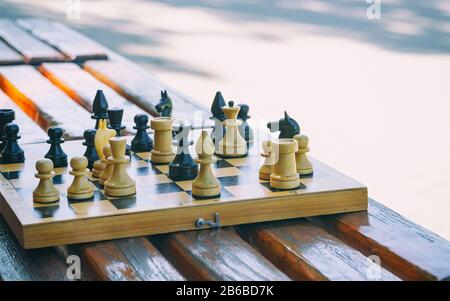 Chess game in the park on the bench. Toned. Retro-style. Stock Photo