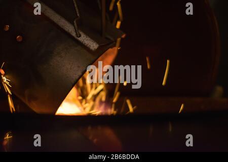 starting up a BBQ on dark evening Stock Photo