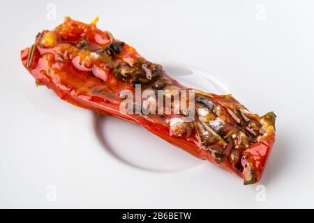 White mold on a spoiled sun dried tomato. Rotten tomato on a white plate. Spoiled fruits and vegetables. Improper storage of vegetables. Close-up. Stock Photo