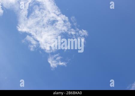 White curly clouds on a blue sky Stock Photo