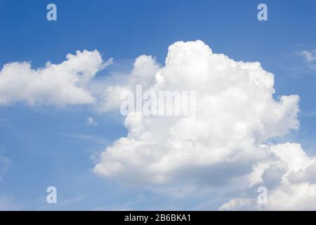 White curly clouds on a blue sky Stock Photo