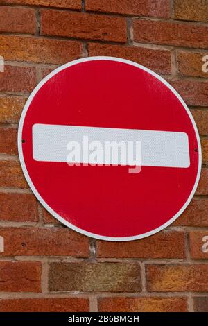 Red circular no entry sign on a brick wall atBirkenhead Wirral August 2019 Stock Photo