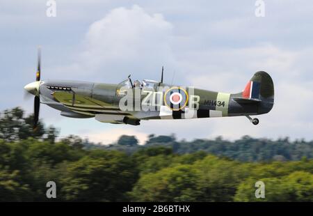 Vintage Supermarine Spitfire MH434, taking-off from Dunsfold airfield, Surrey, England, in August, 2014. Stock Photo