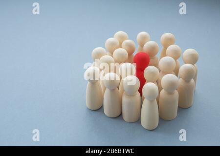 A single red person surrounded by others in a diversity or infectious disease image Stock Photo