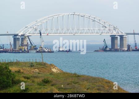 Shipping arch span Crimean bridge across the Kerch Strait. Fairway Stock Photo