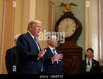 President Donald Trump (C), joined by Treasury Secretary Steven Mnuchin, speaks after meeting with Senate Republicans on a possible economic package in the wake of market turbulence caused by the Coronavirus, on in Washington, DC on March 10, 2020. Credit: Kevin Dietsch/Pool via CNP /MediaPunch Stock Photo