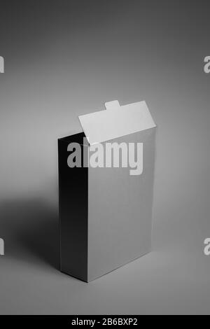 White generic box, studio shot. Blank carton food package, vertical view in low key Stock Photo