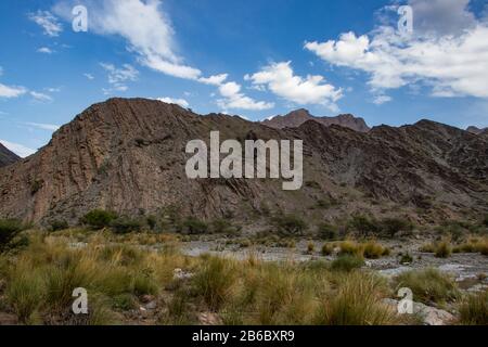 Mountain and valley view along Wadi Sahtan road and snake canyon in Al Hajir mountains between Nizwa and Mascat in Oman Stock Photo