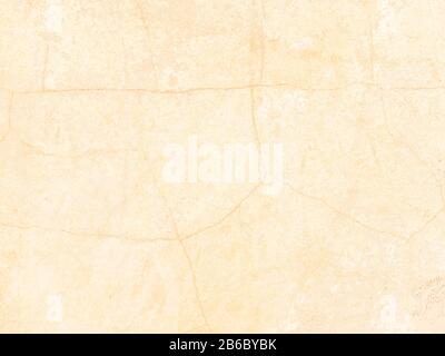 The texture of the wall with the chipped old antique plaster. Abstract background painted in beige and yellow Stock Photo
