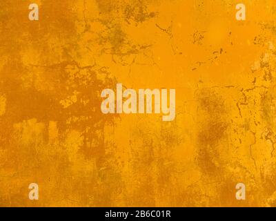 The texture of the wall with the chipped old antique plaster. Abstract background painted in Golden yellow Stock Photo