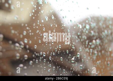 Rain Droplets On Reflective Window Stock Photo