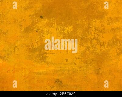 The texture of the wall with the chipped old antique plaster. Abstract background painted in Golden yellow Stock Photo