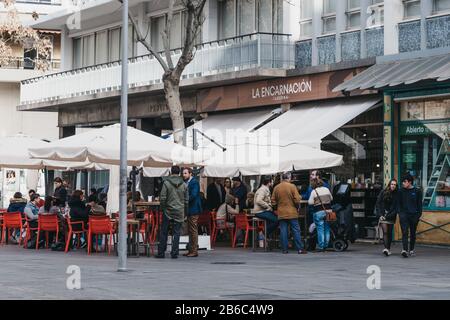 Seville, Spain - January 17, 2020: People at the outdoor tables of La Encarnacion tavern in Seville, the capital of Andalusia region in Southern Spain Stock Photo