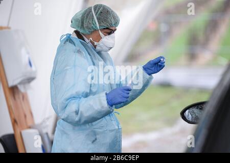 Oberteuringen, Germany. 10th Mar, 2020. A doctor holds a swab in her hands after taking a smear from a patient's throat under a tent in a test centre on the outskirts of town. The swab is then tested for the novel coronavirus. Credit: Felix Kästle/dpa/Alamy Live News Stock Photo