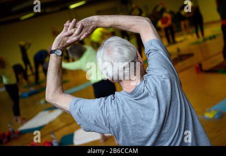 Stuttgart, Germany. 03rd Mar, 2020. Participants stretch during a sports lesson for people over 60. Credit: Sebastian Gollnow/dpa/Alamy Live News Stock Photo