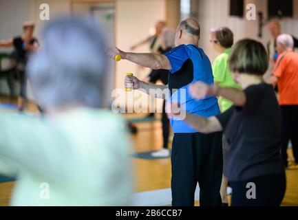 Stuttgart, Germany. 03rd Mar, 2020. Participants do an exercise with light weights during a sports lesson for people over 60. Credit: Sebastian Gollnow/dpa/Alamy Live News Stock Photo