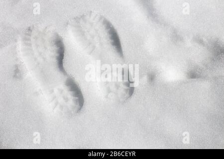 The footprint in snow and natural sunlight. Stock Photo