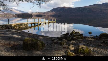 A multi image panorama of a landing stage on Derwent Water taken from a rocky shore. Stock Photo