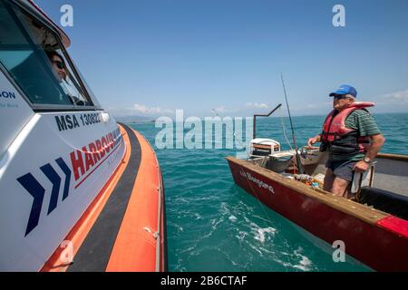 Port Nelson deputy harbourmaster Amanda Kerr on the waters off Port Nelson, Nelson, New Zealand Stock Photo