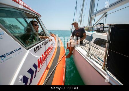 Port Nelson deputy harbourmaster Amanda Kerr on the waters off Port Nelson, Nelson, New Zealand Stock Photo