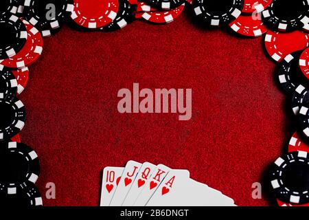 A Royal Heart Flush fanned at the bottom of the frame and a large space for copy in the center of the Dark Red Felt Table Surface surrounded by Red an Stock Photo