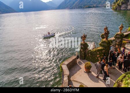 People ejoing a wedding party in Villa del Balbianello on Lake of Como, Lombardy, Italy, at sunset Stock Photo