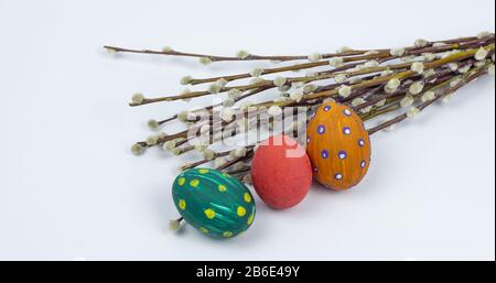 Easter eggs. Happy easter card. Multi-colored Easter eggs with willow. Easter eggs on a white background. Copy space. Place for text Stock Photo