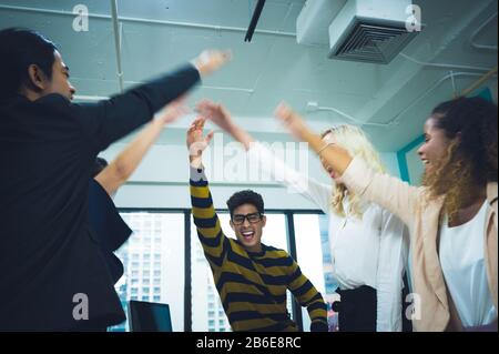 Large business team showing unity with their hands together Stock Photo