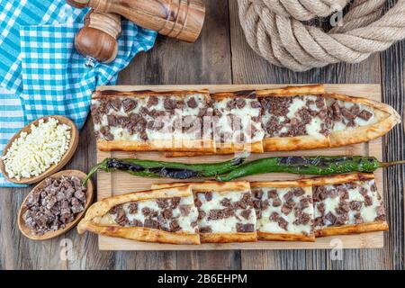 https://l450v.alamy.com/450v/2b6ehpm/turkish-style-pide-with-long-roasted-and-roasted-pide-baked-in-stone-oven-with-cheddar-cheese-turkish-name-kavurmali-kasar-peynirli-pide-2b6ehpm.jpg