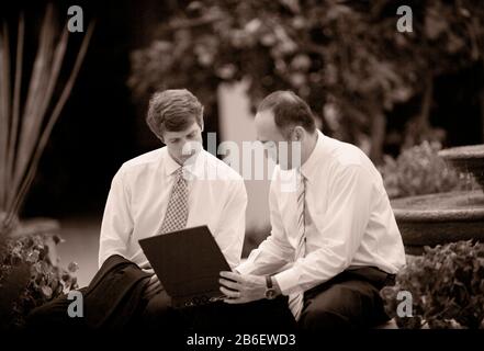 Two business executives working on a laptop Stock Photo