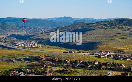 Hot air balloon flying in a valley, Park City, Utah, USA Stock Photo